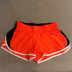 Neon orange Nike running shorts